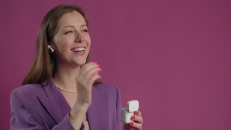 woman in purple blazer with earbuds