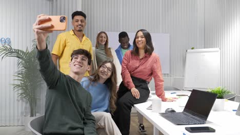 startup team taking a selfie in modern office