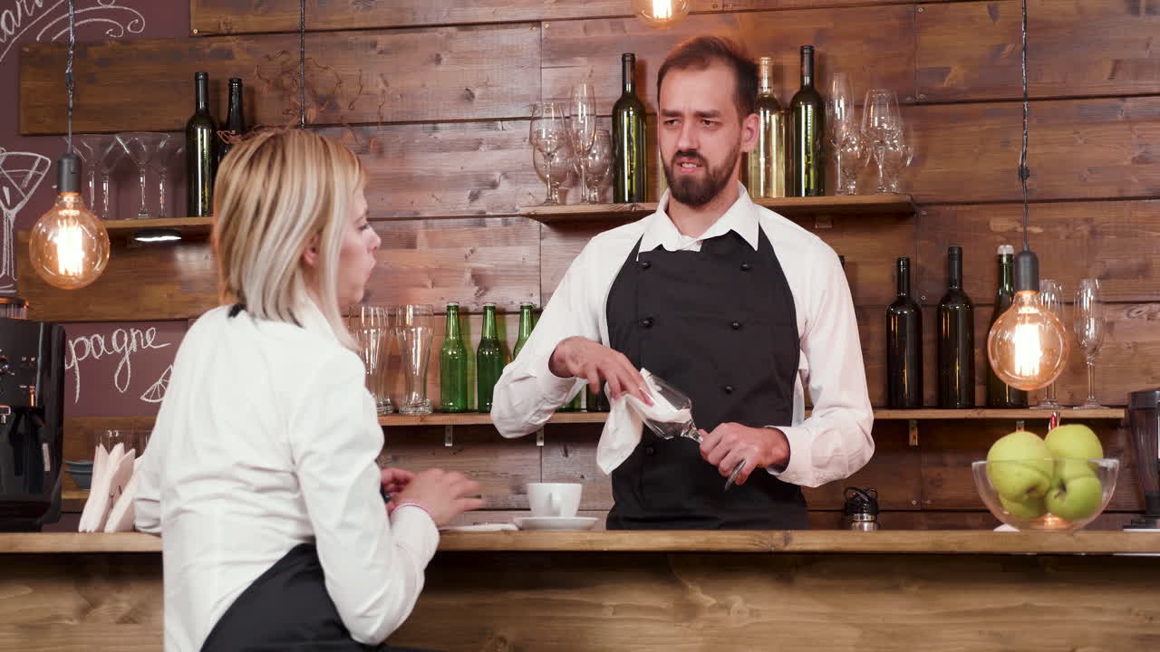 Bartender serving a waitress in a restaurant