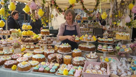 charming pastry market: a delightful display of colorful cakes and baked goods with a welcoming baker at a festive stall