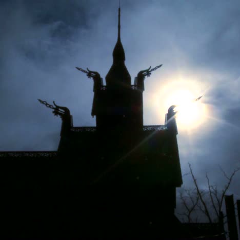 The-sun-shines-behind-a-spooky-stave-church-in-Norway-in-time-lapse