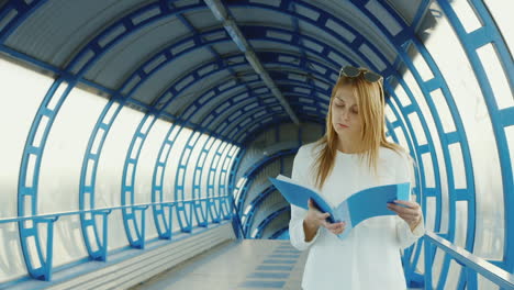 business woman slowly walking on modern glass transition following in the documents folder