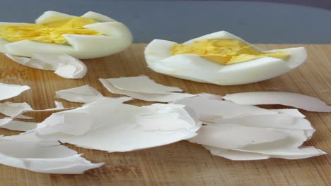 close-up of two peeled hard-boiled eggs on a cutting board