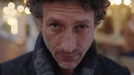 close up portrait of attractive mature confident man looking serious at camera pensive in urban background