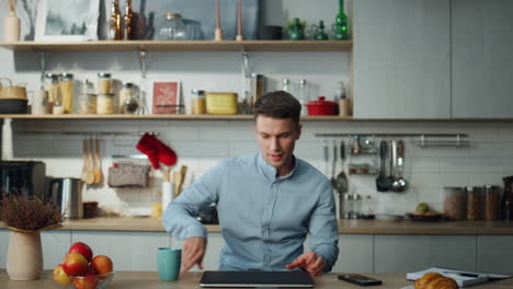 freelance worker enjoying remote job at home. guy dancing before working online.