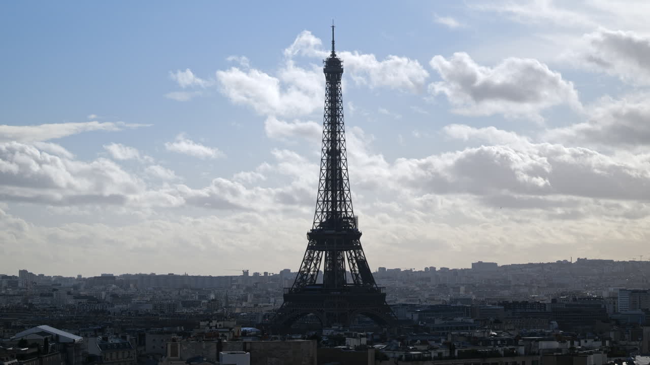 The Eiffel Tower stands tall amidst a sprawling cityscape.