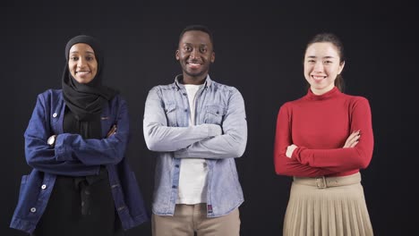 Happy-multiethnic-friends-smiling-at-camera-and-clasping-their-hands.