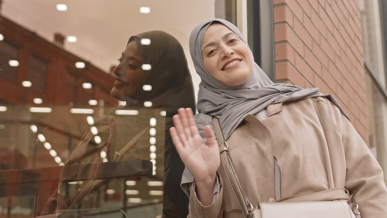 Arabic Woman Waving to Camera