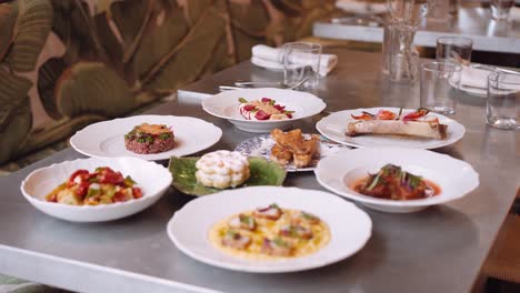 set table in an italian restaurant with several dinner courses