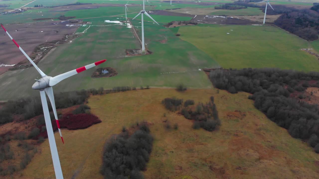 Close up pan left windmill turbine view creating sustainable green power, aerial high angle