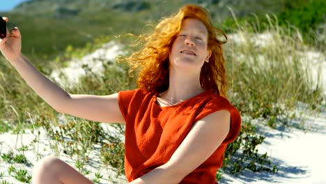 woman taking selfie with mobile phone at beach 4k