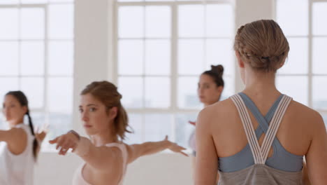 yoga class instructor teaching reverse warrior pose to beautiful group of women enjoying healthy lifestyle exercising in fitness studio meditation