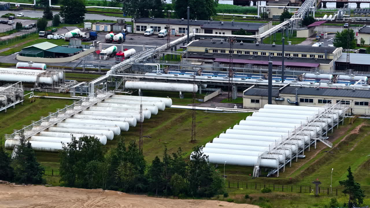 Gas processing plant with pipelines and storage tanks in drone view