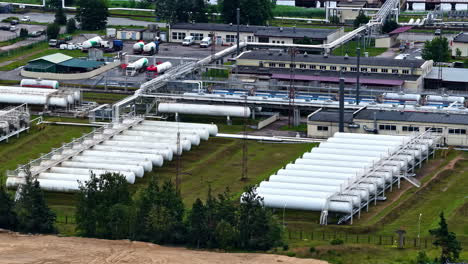 gas processing plant with pipelines and storage tanks in drone view