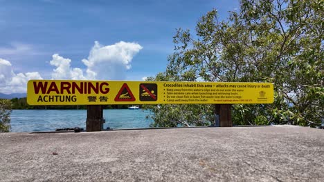 warning achtung sign warning people crocodiles inhabit the area and attacks may cause injury or death