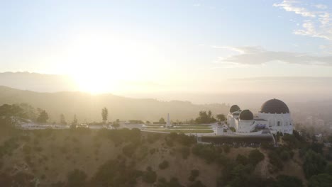 gorgeous aerial push in to the griffith observatory during sunrise