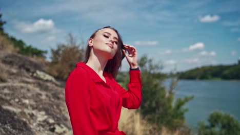 flirting woman posing on nature. close up portrait of beautiful young woman enjoying on nature