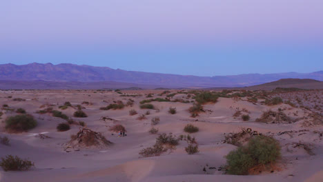 drone circles around the desert very close to the sand dunes