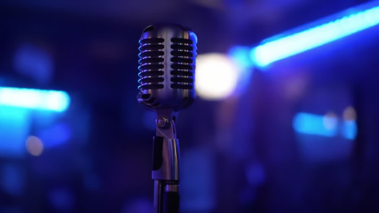 A Classic Microphone Captured in an Atmospheric Setting with Blue Lighting, Perfectly Emphasizing Its Timeless Design and Role in Music Performance