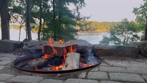 campfire by the lake at sunset