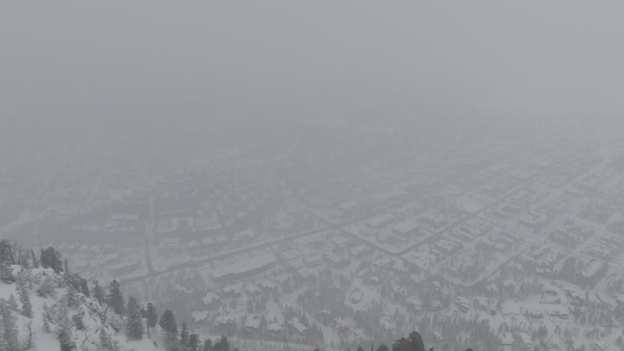 Forward moving drone view of snowstorm at Copper Mountain in Colorado, USA.