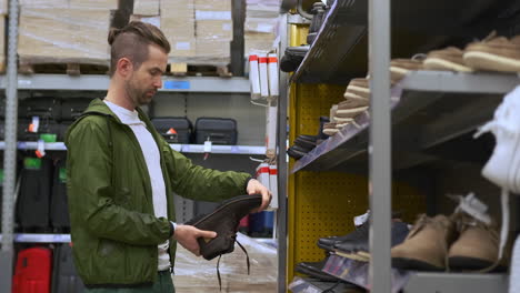 man shopping for shoes in a retail store