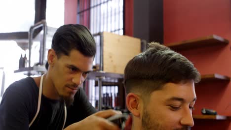 man interacting with barber while trimming his hair 4k