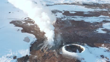 amazing volcanic geyser emitting steam, gunnuhver geothermal field, aerial