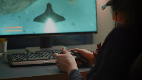 closeup of competitive woman player holding joystick playing space shooter