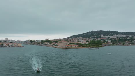 aerial view motor boat with scientists navigating out of the canal in sète, france