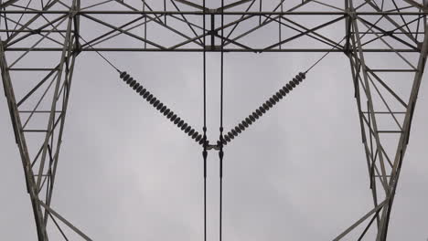 close-up of electrical insulators and electrical pylon tower structure