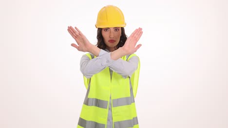 Woman construction worker making a stop or no gesture with crossed arms