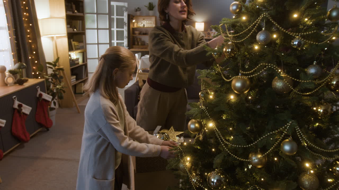 Family decorating Christmas tree with ornaments