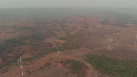 descending drone shot of windmills on a dry plateau