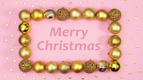 el texto de feliz navidad aparece en el marco de adornos de oro de navidad en tema rosa.