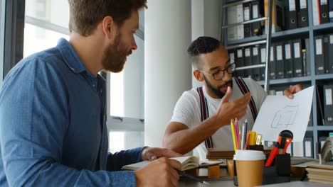 Male-architects-interacting-with-each-other-at-desk-4k