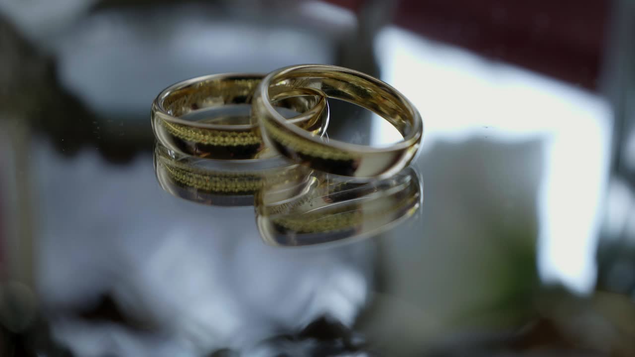 Luxury Gold Wedding Bands on Transparent Table Detail