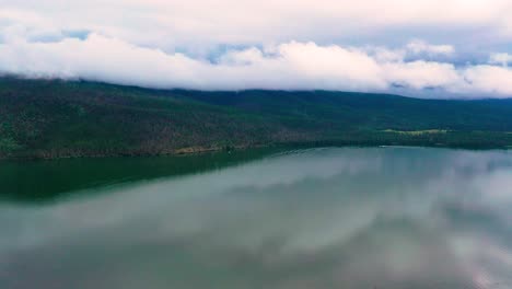 Wunderschöner-Klarer-See-Mit-Atemberaubenden-Wolkigen-Hügeln-Im-Hintergrund-Eines-Ruhigen-Bergreservoirs