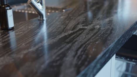 modern black granite countertop on an island in the kitchen of a home