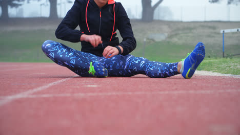 Front-view-of-young-Caucasian-female-athlete-exercising-on-a-running-track-4k