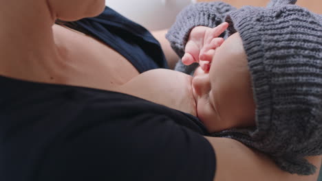 mother breastfeeding baby at home mom nursing infant nurturing child suckling milk from breast motherhood maternity care