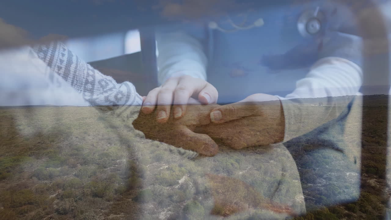 Holding patient's hand, healthcare professional symbolizing care over serene landscape