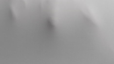 a creepy silhouette of a woman's body appears from the white surface