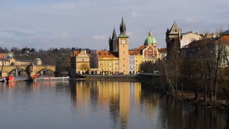 vltava river, old town waterworks tower and charles bridge in prague, czech republic