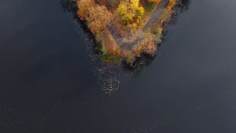 Aerial-view-of-beautiful-smooth-green-waters-of-a-lake-on-a-sunny-autumn-day