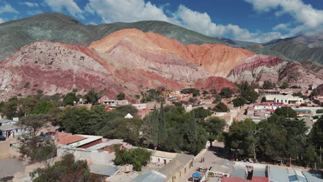 aerial view above the tourist town purmamarca, surrounded by cerro siete colores