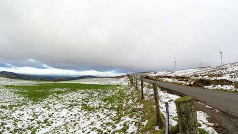 snowy rural winter weather over valley countryside aerial agricultural farmland landscape timelapse