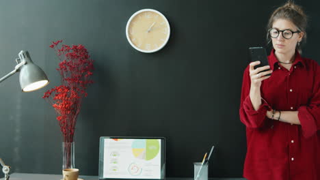 businesswoman using phone in modern office