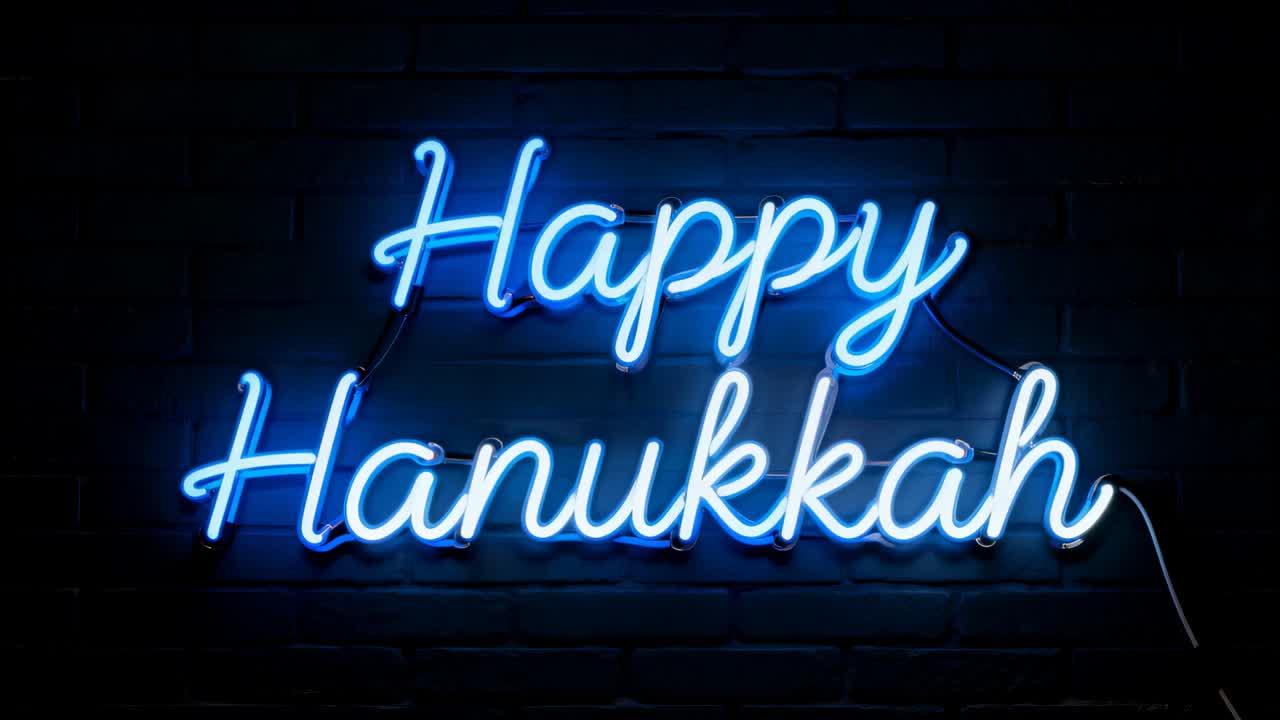 Slow zooming camera revealing blue neon sign reading Happy Hanukkah on brick wall, showing wiring