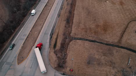 red-semi-tractor-with-white-reefer-dryvan-trailer-doing-right-turn